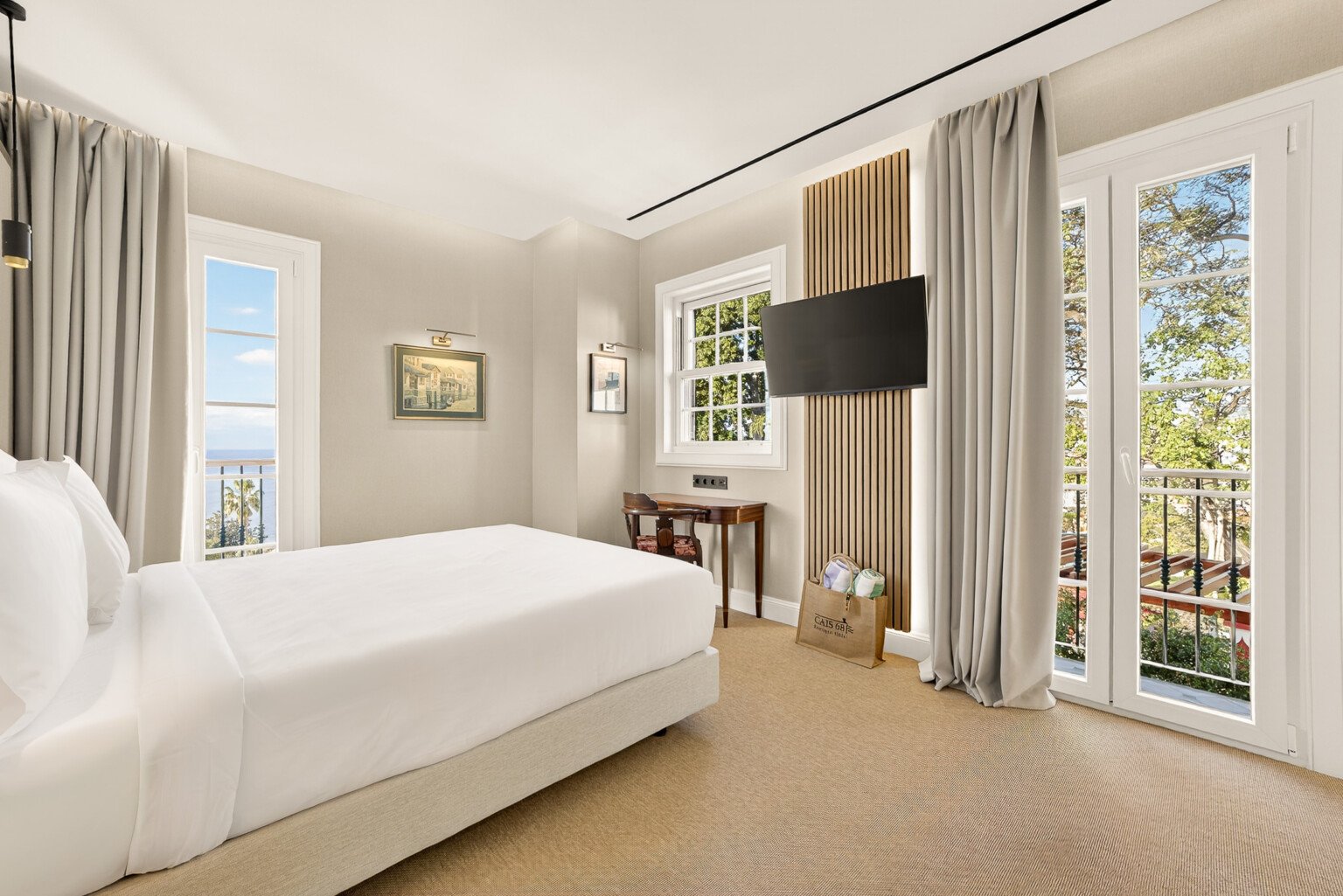The 250º W suite: the bed on the left and the balcony doors ahead, in winter light