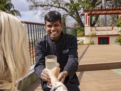 The concierge serving a drink on the deck at Cais 68, Funchal